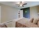 This is a bedroom with a ceiling fan, a decorative wall and neutral toned walls and flooring at 710 Marie Ln, Fortville, IN 46040