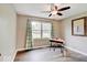 Bedroom with a ceiling fan, large window, and a quaint desk area at 710 Marie Ln, Fortville, IN 46040