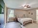 Bedroom boasts a comfortable bed, a ceiling fan, and a scenic window view at 710 Marie Ln, Fortville, IN 46040