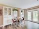 Dining area featuring natural light, stylish decor, and seamless flow to the outdoors at 710 Marie Ln, Fortville, IN 46040
