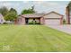 Charming brick ranch home with a well-manicured lawn and attached two car garage at 710 Marie Ln, Fortville, IN 46040