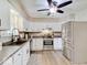 The kitchen features stainless steel appliances, white cabinets, and sleek countertops at 710 Marie Ln, Fortville, IN 46040
