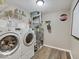 A well-equipped laundry room with modern washer, dryer, and ample storage shelving at 710 Marie Ln, Fortville, IN 46040