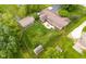 Expansive aerial view of home with a fenced backyard, patio, outbuildings, and mature trees at 7135 Lantern Rd, Indianapolis, IN 46256