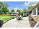 Outdoor patio boasts dining set and lush green lawn with an outbuilding, perfect for entertaining at 7135 Lantern Rd, Indianapolis, IN 46256