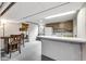 Basement area equipped with kitchen and eating area featuring white cabinets and appliances at 7135 Lantern Rd, Indianapolis, IN 46256