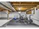 Finished basement featuring workout and exercise equipment in a brightly lit room at 7135 Lantern Rd, Indianapolis, IN 46256