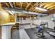 Basement area with workout equipment, desk space, exposed ducts, and wood beams at 7135 Lantern Rd, Indianapolis, IN 46256