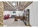Finished basement space featuring an office setup, piano, and comfortable seating area at 7135 Lantern Rd, Indianapolis, IN 46256