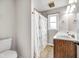 Bathroom with a double sink vanity, decorative fixtures, tile floor, and a window for natural light at 7135 Lantern Rd, Indianapolis, IN 46256