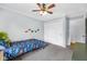 Cozy bedroom featuring carpeting, a ceiling fan, a large closet, and dinosaur themed decorations at 7135 Lantern Rd, Indianapolis, IN 46256