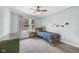 Bedroom featuring neutral carpet, ceiling fan, and large window, showcasing the cozy interior at 7135 Lantern Rd, Indianapolis, IN 46256
