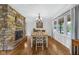 Charming dining room with stone fireplace and great natural light from the large window at 7135 Lantern Rd, Indianapolis, IN 46256