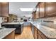 Open floor plan kitchen with granite counters, stainless appliances and direct access to the living room at 7135 Lantern Rd, Indianapolis, IN 46256