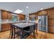 Bright kitchen with granite counters, stainless steel appliances, and a center island with seating at 7135 Lantern Rd, Indianapolis, IN 46256