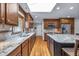 Modern kitchen with granite countertops, stainless steel appliances, central island, and a view of the exterior at 7135 Lantern Rd, Indianapolis, IN 46256