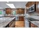 Bright eat-in kitchen features stainless steel appliances, granite counters and a large skylight at 7135 Lantern Rd, Indianapolis, IN 46256