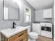 Updated laundry area boasts modern appliances, sink, and convenient storage at 7135 Lantern Rd, Indianapolis, IN 46256