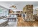 Spacious living room with a large stone fireplace, hardwood floors, and a comfortable sectional sofa at 7135 Lantern Rd, Indianapolis, IN 46256