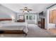 Spacious main bedroom with a bay window, neutral carpet, and en-suite bathroom at 7135 Lantern Rd, Indianapolis, IN 46256