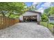 Large outbuilding with an open garage door and gravel driveway, providing ample space for storage at 7135 Lantern Rd, Indianapolis, IN 46256