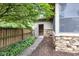 Stone accent wall on the side of the house with a landscaped walkway leading to the screened-in porch entrance at 7135 Lantern Rd, Indianapolis, IN 46256