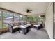 Cozy sunroom with comfortable wicker furniture, ceiling fan, and view of the backyard at 7135 Lantern Rd, Indianapolis, IN 46256