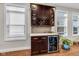 An entertainment bar includes a built in wine rack, upper and lower cabinets, and a beverage refrigerator at 715 Terrace Ave, Indianapolis, IN 46203