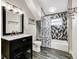 Updated bathroom with modern vanity, stylish tiling, and shower-tub combination at 715 Terrace Ave, Indianapolis, IN 46203