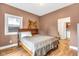 Bedroom featuring wood floors, a window with natural light, and tan painted walls at 715 Terrace Ave, Indianapolis, IN 46203