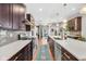 Kitchen view featuring stainless appliances, an island with seating, backsplash, and hardwood flooring that flows throughout the house at 715 Terrace Ave, Indianapolis, IN 46203