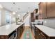 Bright kitchen features hardwood floors, stainless steel appliances, and a large center island with a white countertop at 715 Terrace Ave, Indianapolis, IN 46203