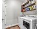 This is a laundry room with white washer and dryer and an open shelf at 715 Terrace Ave, Indianapolis, IN 46203