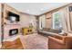 Comfortable living room with brick fireplace, decorative rug and natural light at 715 Terrace Ave, Indianapolis, IN 46203
