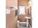 Charming powder room with pedestal sink, mirror and neutral colors at 715 Terrace Ave, Indianapolis, IN 46203