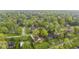 A neighborhood featuring well-maintained homes surrounded by mature trees and landscaping at 7153 N Audubon Rd, Indianapolis, IN 46250