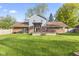A spacious backyard features a well-maintained lawn and a large patio area for outdoor enjoyment at 7153 N Audubon Rd, Indianapolis, IN 46250