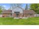 Backyard featuring a deck, a well-manicured lawn, and a combination of brick and siding exterior at 7153 N Audubon Rd, Indianapolis, IN 46250