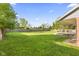A spacious backyard features a well-maintained lawn and a large patio area for outdoor enjoyment at 7153 N Audubon Rd, Indianapolis, IN 46250
