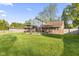 A spacious backyard features a well-maintained lawn and a large patio area for outdoor enjoyment at 7153 N Audubon Rd, Indianapolis, IN 46250