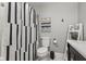 A stylish bathroom features striped shower curtain, a modern toilet, and decorative accents at 7153 N Audubon Rd, Indianapolis, IN 46250