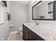 Bathroom featuring a marble countertop vanity and a framed mirror with modern lighting at 7153 N Audubon Rd, Indianapolis, IN 46250