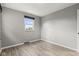 Bedroom featuring a window, wood-look flooring, and neutral walls at 7153 N Audubon Rd, Indianapolis, IN 46250
