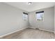 A well-lit bedroom features wood floors and two windows that provide natural light at 7153 N Audubon Rd, Indianapolis, IN 46250