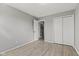 Empty bedroom showcasing wood-look flooring and a closet at 7153 N Audubon Rd, Indianapolis, IN 46250