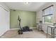 An inviting exercise room with sleek fitness equipment, neutral paint and wood flooring, illuminated by bright, natural light at 7153 N Audubon Rd, Indianapolis, IN 46250