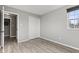 Empty bedroom showcasing wood-look flooring, a closet, and a window at 7153 N Audubon Rd, Indianapolis, IN 46250