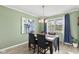 Dining room with a modern chandelier, a window, and a table with chairs at 7153 N Audubon Rd, Indianapolis, IN 46250