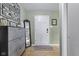 Entryway featuring modern decor, light green walls, a white door, and wood-look flooring at 7153 N Audubon Rd, Indianapolis, IN 46250