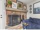 Brick fireplace with mantle and screen in a cozy living room with blue couch at 7153 N Audubon Rd, Indianapolis, IN 46250